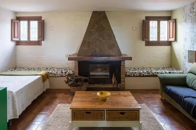 a living room with a fireplace and a couch at El mirador de la Sonora in Artana
