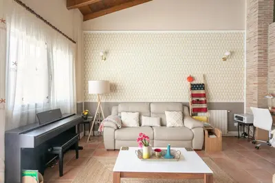 a living room with a piano and a couch at Luxury villa close to beach, mountain and golf! in Alzira