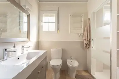 a white bathroom with a toilet and a sink at Luxury villa close to beach, mountain and golf! in Alzira