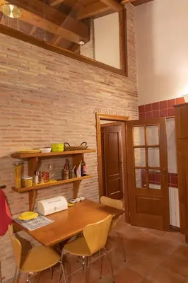 a dining room with a wooden table and chairs at Luxury villa close to beach, mountain and golf! in Alzira