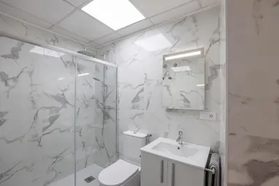 a bathroom with a toilet and a sink and a shower at Apartamentos Grupo Torres de Quart in Valencia