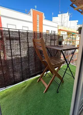 a wooden chair sitting on a balcony with a table at Casa Lúmina Laura-Valencia in Valencia