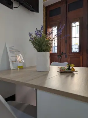 a table with a plate of food on top of it at Las Arenas Suites 3 in Valencia