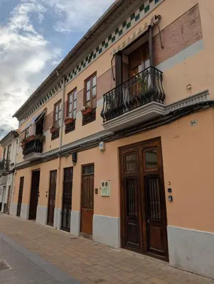 a building with windows and doors on a street at Las Arenas Suites 3 in Valencia