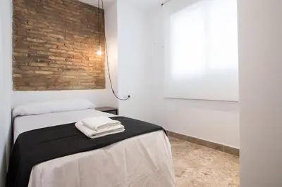 a bedroom with a bed with two towels on it at Apartamentos La Marina in Valencia