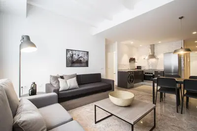 a living room with a couch and a table at Apartamentos La Marina in Valencia