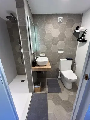 a bathroom with a toilet and a sink and a shower at Finca Malata in Turís