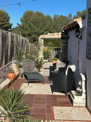 a patio with two chairs and a table at Finca Malata in Turís