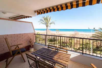 a balcony with a bench and a view of the beach at Global Vacacional, Apartamento en primera linea con impresionantes vistas al mar in Canet de Berenguer