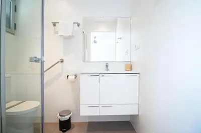 a white room with two beds and a window at Global Vacacional, Apartamento en primera linea con impresionantes vistas al mar in Canet de Berenguer