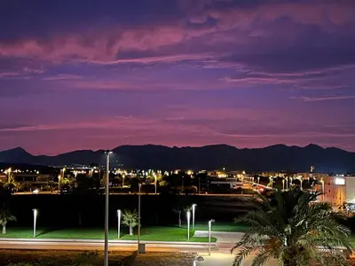 a night view of a city with mountains in the background at Moncofa Sunset in Moncófar