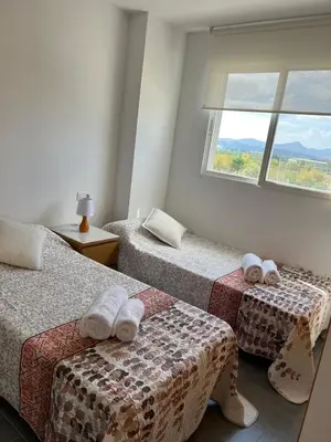 a room with two beds and a window at Moncofa Sunset in Moncófar