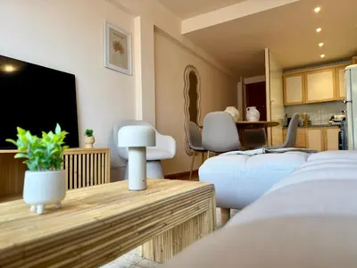 a room with two beds and a flat screen tv at Casa Palmera in Sueca