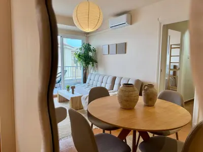 a living room with a table and chairs and a couch at Casa Palmera in Sueca
