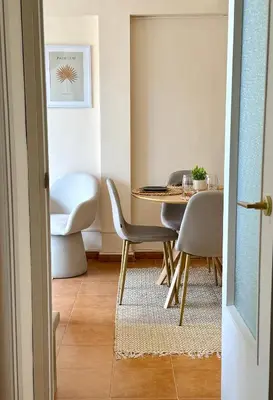 a dining room with a table and chairs at Casa Palmera in Sueca