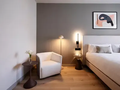 a bedroom with a large white bed with two lamps at Numa Valencia El Carmen in Valencia