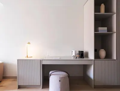a room with a desk and a chair next to a table at Numa Valencia El Carmen in Valencia