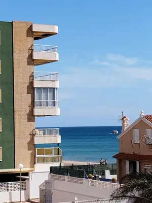 a view of the ocean from a building at Parking Privado l Terraza Relajante Junto Al Mar in Tavernes de Valldigna
