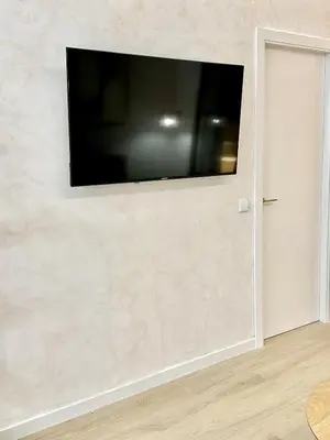 a flat screen tv hanging on a wall at Anelsa Suites Serranos 3 in Valencia