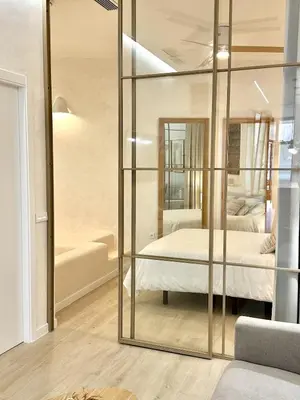 a room with a glass partition with a bed in it at Anelsa Suites Serranos 3 in Valencia