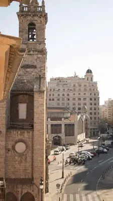 a tall brick building with a clock tower on a street at Piso 4 - Apartamento Mercado Central in Valencia