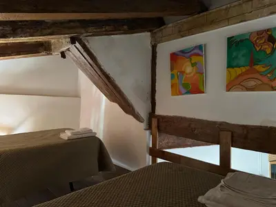 a bedroom with a bed and paintings on the wall at Piso 4 - Apartamento Mercado Central in Valencia