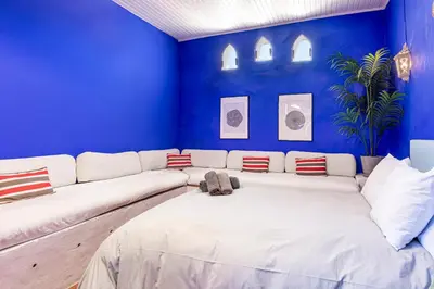 a living room with a white couch in a blue wall at Romantic Mediterranean Riad in Tavernes de Valldigna