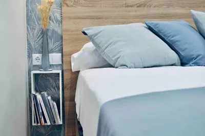 a bedroom with a bed with blue and white pillows at Beautiful modern loft 1km from the sea in Valencia in Valencia