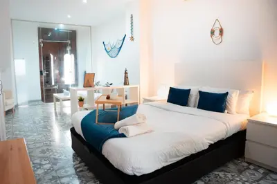 a bedroom with a large bed with towels on it at Apartamento a 7 minutos de la playa y cerca de la estación de autobús in Valencia