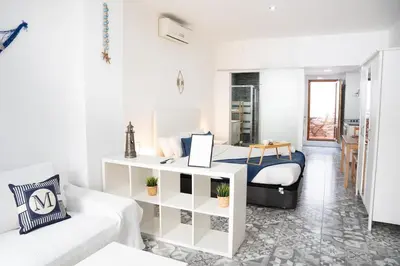 a white room with a bed and a couch at Apartamento a 7 minutos de la playa y cerca de la estación de autobús in Valencia