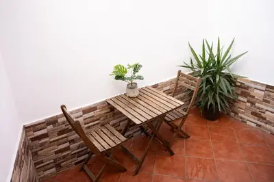 a small table and chairs on a patio at Apartamento a 7 minutos de la playa y cerca de la estación de autobús in Valencia