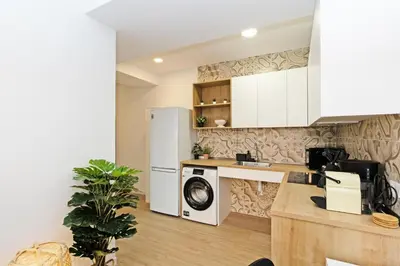 a kitchen with a washer and a washing machine in it at GuestReady - Cozy flat in Valencia in Valencia