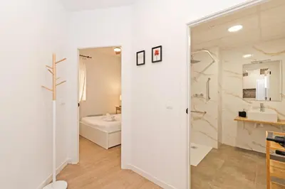 a white bathroom with a sink and a mirror at GuestReady - Cozy flat in Valencia in Valencia