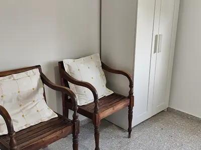 a wooden chair with a pillow on top of it at La Casa de los Alemanes in Gaibiel