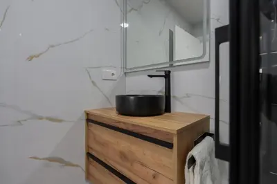 a bowl on top of a wooden dresser in a bathroom at La plata 59 in Valencia