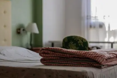a pile of towels sitting on top of a bed at Plaza Mare Nostrum 5 min playa in Puerto de Sagunto
