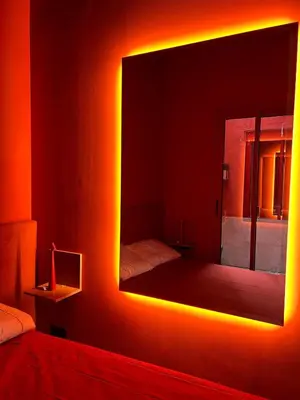 a bedroom with a mirror and a bed in a room at Apartamento de diseño a 500 metros de la playa in Valencia