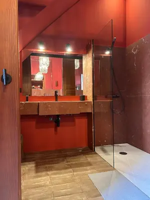a bathroom with a sink and a shower with a mirror at Apartamento de diseño a 500 metros de la playa in Valencia