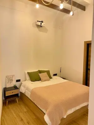 a bedroom with a bed and a camera on the wall at Acogedor bajo en Valencia in Valencia