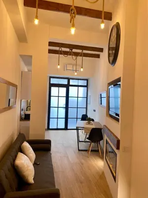 a living room with a couch and a table at Acogedor bajo en Valencia in Valencia