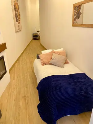 a bedroom with a bed with a blue blanket on it at Acogedor bajo en Valencia in Valencia