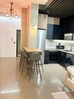 a kitchen with a wooden table and chairs in it at FALLAS en el barrio del Carmen, el corazón de Valencia in Valencia
