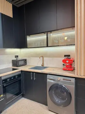 a kitchen with a washing machine and a sink at FALLAS en el barrio del Carmen, el corazón de Valencia in Valencia