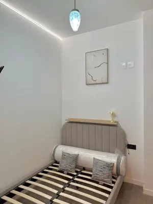 a bedroom with a bed with two pillows on it at FALLAS en el barrio del Carmen, el corazón de Valencia in Valencia