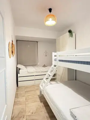 a bedroom with a bunk bed and two beds at UIM Mediterraneo Virgen del Carmen 2 Wifi in Puerto de Sagunto