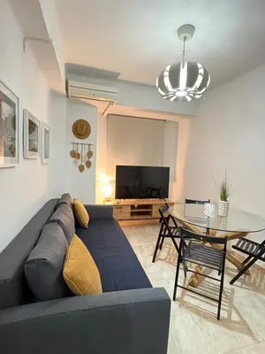 a living room with a couch and a table at UIM Mediterraneo Virgen del Carmen 2 Wifi in Puerto de Sagunto