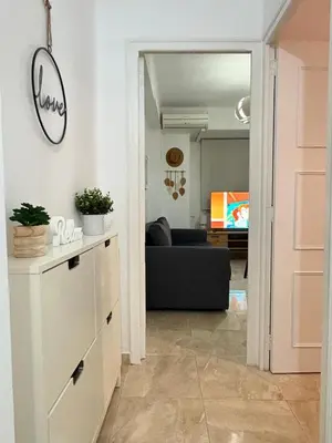 a hallway with a living room with a couch at UIM Mediterraneo Virgen del Carmen 2 Wifi in Puerto de Sagunto