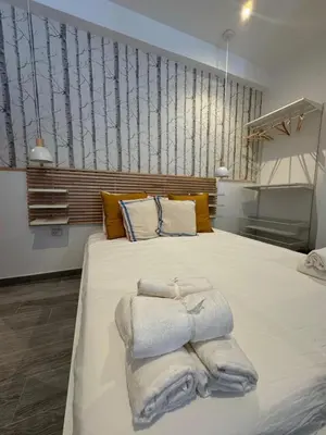 a bedroom with a large bed with towels on it at Loft in Valencia, equipped and very well decorated in Valencia