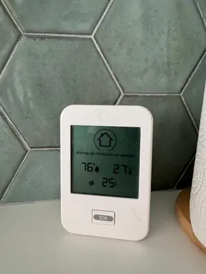 a digital clock sitting on a counter in a bathroom at Loft in Valencia, equipped and very well decorated in Valencia