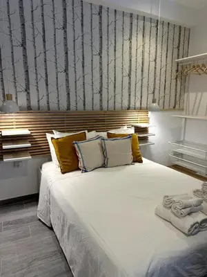 a bedroom with a large white bed with yellow pillows at Loft in Valencia, equipped and very well decorated in Valencia
